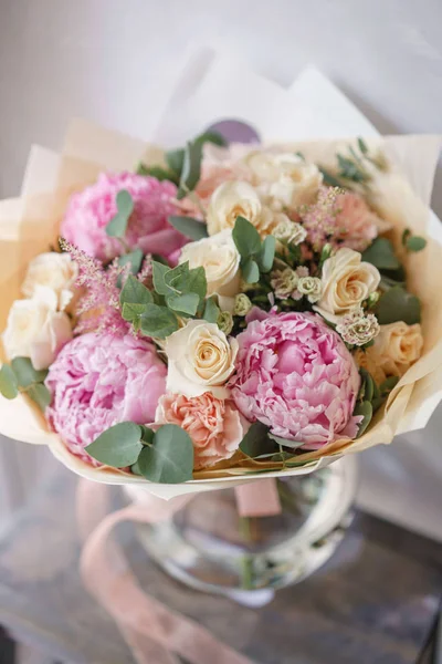 beautiful summer bouquet. flower arrangement with peonies. Color light pink. The concept of a flower shop.