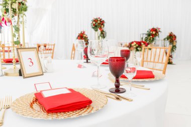 Bir düğün için bir çadır altında güzel ziyafet salonu. İç bir düğün çadırı dekorasyon misafirler için hazır. Dekor çiçek. Kırmızı Tema