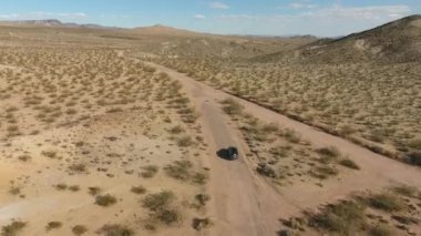 Uçuş monument Valley Utah - Hava uçak Arizona'da otomobil uzun otoban üzerinden. Ana sayfa görünümü dron görüntüleri uçan kuru ve bej Çölü üzerinde kuraklık manzara, küresel ısınma tehdit sonuçlandı