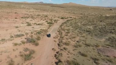Uçuş monument Valley Utah - Hava uçak Arizona'da otomobil uzun otoban üzerinden. Ana sayfa görünümü dron görüntüleri uçan kuru ve bej Çölü üzerinde kuraklık manzara, küresel ısınma tehdit sonuçlandı