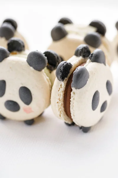 Delicious almond desserts in the form of Panda. French macaron cookies.