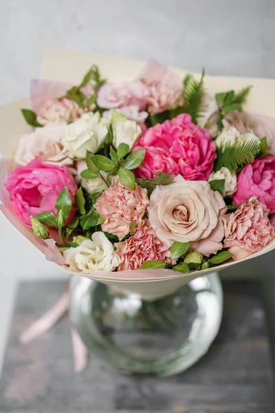 beautiful summer bouquet. flower arrangement with peonies. Color light pink. The concept of a flower shop.