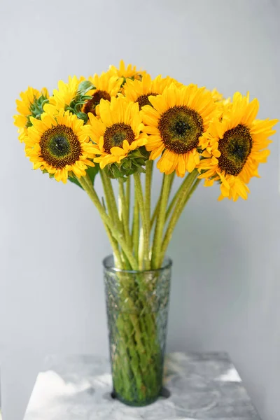 Bouquet of yellow sunflowers , flower in vase on old vintage table. Room morning. Gray background. Colors of autumn and mood fall