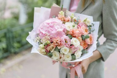 Güzel yaz buket. Mix çiçek aranjmanı. Ortanca çiçek aranjmanı tutan genç kız. Bir çiçekçi dükkanı kavramı. Katalog için içerik