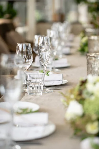 Wedding Banquet or gala dinner. The chairs and table for guests, served with cutlery and crockery. Covered with a linen tablecloth runner. party on terrace