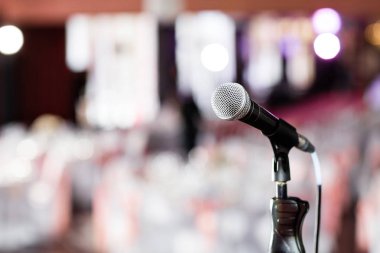 Mikrofon üzerinden soyut ziyafet salonu veya seminer odası insanlar arka plan, parti veya toplantı konsepti ile fotoğraf bulanık.