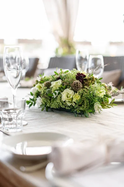 Wedding Banquet or gala dinner. The chairs and table for guests, served with cutlery and crockery. Covered with a linen tablecloth runner. party on terrace