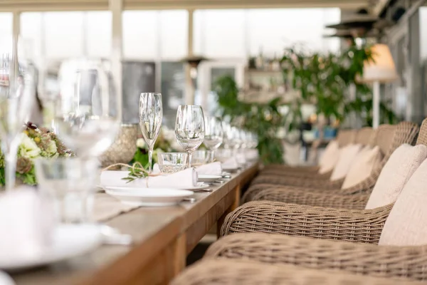 Wedding Banquet or gala dinner. The chairs and table for guests, served with cutlery and crockery. Covered with a linen tablecloth runner. party on terrace