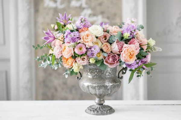 Gorgeous bouquet of different flowers. floral arrangement in vintage metal vase. table setting. lilac and peach color — Stock Photo, Image