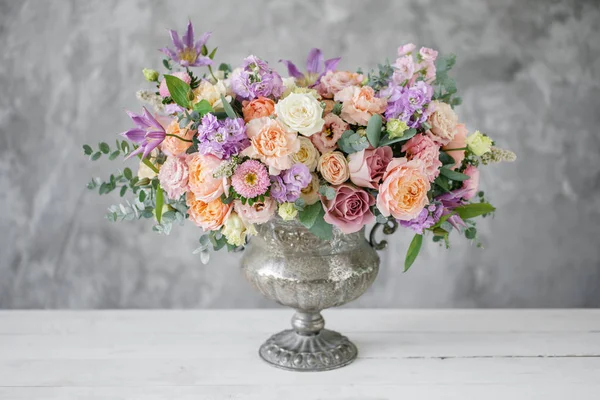 Gorgeous bouquet of different flowers. floral arrangement in vintage metal vase. table setting. lilac and peach color — Stock Photo, Image