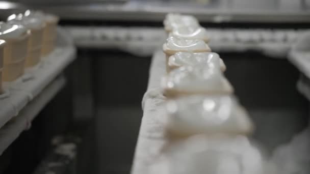 Μηχάνημα ρομπότ αυτόματα χύνει παγωτά σε ένα Κύπελλα γκοφρέτα. Η μεταφορική Αυτόματες γραμμές για την παραγωγή χωνάκια παγωτού. Κύπελλα γκοφρέτα και κώνοι. Μεγάλες βιομηχανικής παραγωγής. — Αρχείο Βίντεο