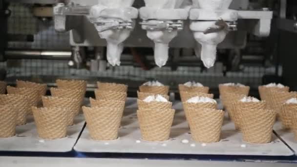 Robot machine Vierte automáticamente helado en una copa de oblea. Las líneas automáticas transportadoras para la producción de conos de helado. Copas de obleas y conos. Gran producción industrial . — Vídeos de Stock