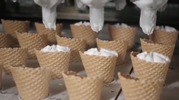 Robotermaschine gießt automatisch Eis in einen Waffelbecher. die automatischen Förderanlagen für die Herstellung von Eistüten. Hostientassen und Zapfen. große industrielle Produktion. — Stockvideo