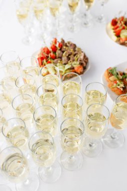 ciddi mutlu yeni yıl ziyafet. Çok fazla bardak şampanya veya şarap Restoran tablo. büfe masa aperatifler dolu. kanepeler, bruschetta ve ahşap plaka tahta üzerinde küçük tatlılar