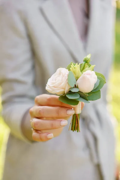 Ανοιξιάτικη διάθεση. Νεαρή κοπέλα που κρατά έναν όμορφο γάμο μπουτονιέρα. Ανθοσύνθεση με παστέλ χρώμα λουλούδια. Λαμπερό ξημέρωμα ή ηλιοβασίλεμα ήλιος — Φωτογραφία Αρχείου