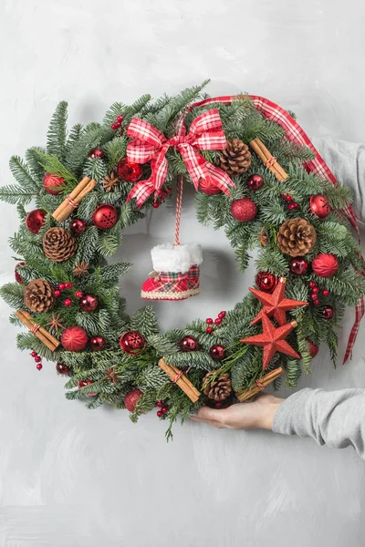 Preparação para o conceito de férias. Bela grinalda de Natal em mãos de mulher. Florista é um trabalho principal de um florista profissional . — Fotografia de Stock