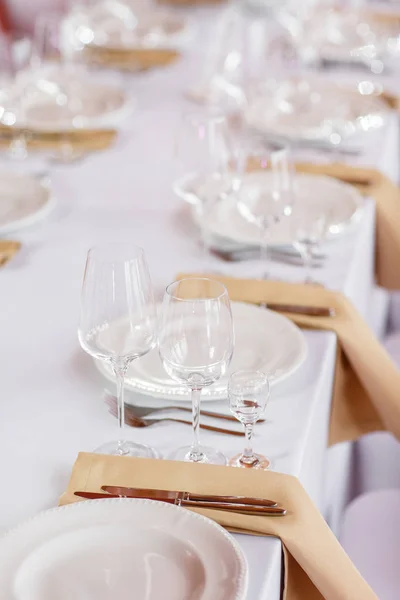 Mesa en una recepción de boda de lujo. Hermosas flores en la mesa. Sirve platos, vasos de vidrio, camareros trabajan , —  Fotos de Stock