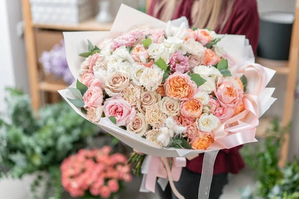 European floral shop. Bouquet of beautiful Mixed flowers in woman hand. Excellent garden flowers in the arrangement , the work of a professional florist. — Stock Photo, Image