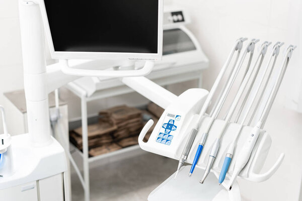 Stomatological instrument in the dentists clinic. Dental work in clinic. Operation, tooth replacement. Medicine, health, stomatology concept. Office where dentist conducts inspection and concludes.