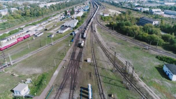 Logistikkonzept. Güterzüge sortieren sich in vielerlei Hinsicht neu. Industrielle Eisenbahnlandschaft. Eisenbahngleise. Aufnahme von oben mit Quadrocopter. — Stockvideo