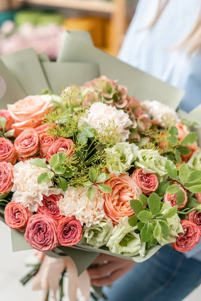 European floral shop. Bouquet of beautiful Mixed flowers in woman hand. Excellent garden flowers in the arrangement , the work of a professional florist. — Stock Photo, Image