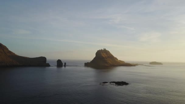 Wyspy Owcze, Wyspy Północnego Atlantyku w zachód słońca. Drangarnir jest wspólna nazwa dla dwóch stosy morza między wysepka Tindholmur i Wyspa Vagar. Fotografowania drona drone, — Wideo stockowe