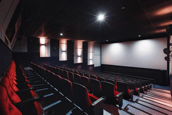 Russia, Nizhny Novgorod - may 26, 2014: Sormovsky Cinema. Empty red cinema hall seats, comfortable and soft chairs. Perspective auditorium view with white space on the screen — Stock Photo, Image