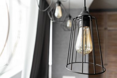 loft tarzı demir abajur ile modern daire iç oturma odasında bir ampul. Vintage tarzı Işık Ampüller. cam ampuller ile duvarda bir spiral yuvarlak.