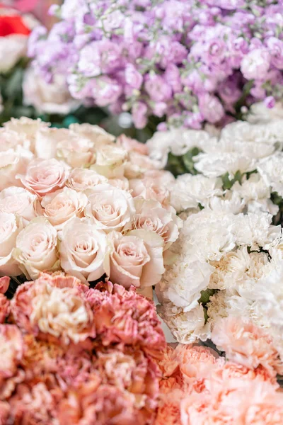 Alfombra floral, textura floral, concepto de tienda. Hermosas flores frescas en flor rosas, rosas en aerosol, gillyflower lila y clavel. Flor de color pastel en jarrones y cubos. Vista superior . —  Fotos de Stock
