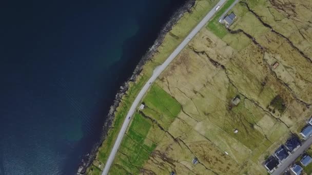 North Atlantic islands in sunset. The car goes on the road along the coast, Shooting from the quadrocopter — Stock Video