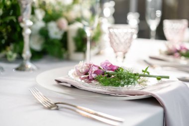 Closeup sofra plakaları ve sofra, çiçeklerle süslenmiş. Çiçek dekorasyon düğün töreni romantik yemek için. Düğün Ziyafet, Festival dekor. Servis ve ikram konsepti.
