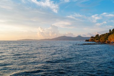Summer sunrise on coast, Corfu island, Greece. Beach with perfect views of the mainland Greece mountains.