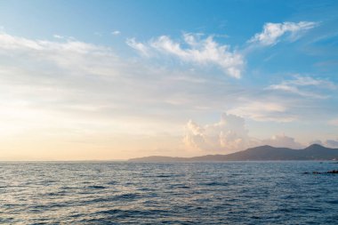 Summer sunrise on coast, Corfu island, Greece. Beach with perfect views of the mainland Greece mountains.