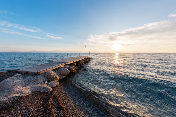 Summer sunrise on coast, Corfu island, Greece. Beach with perfect views of the mainland Greece mountains.