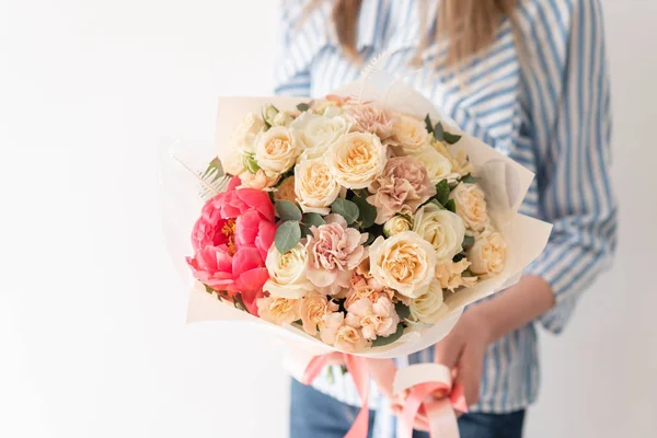 Coral peony. Beautiful bouquets of mixed flowers in womans hands. the work of the florist at a flower shop. Delicate Pastel color. Fresh cut flower. — Stock Photo, Image