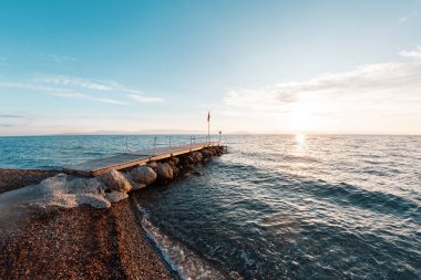 Summer sunrise on coast, Corfu island, Greece. Beach with perfect views of the mainland Greece mountains.