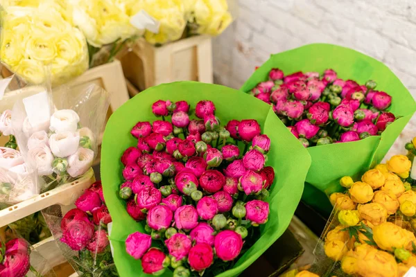 Warehouse refrigerator, Wholesale flowers for flower shops. Persian Buttercup, Ranunculusin a plastic container or bucket. Online store. Floral shop and delivery concept.