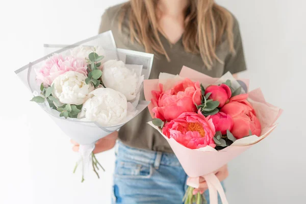 Dos hermosos ramos. Coral y peonías blancas en la mano de las mujeres. Hermosa flor de peonía para catálogo o tienda en línea. Concepto de tienda floral. Recién cortado Flores delivery — Foto de Stock