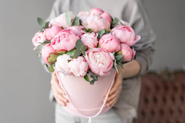 Pink peonies in womans hands. Beautiful peony flower for catalog or online store. Floral shop concept . Beautiful fresh cut bouquet. Flowers delivery