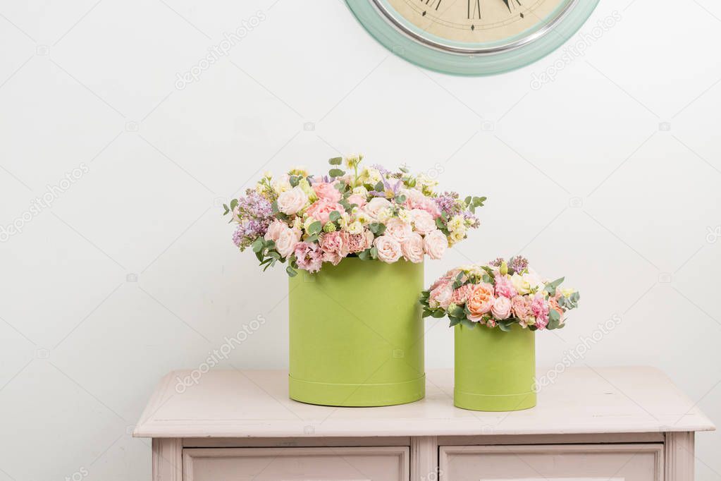 Two Beautiful spring bouquets in head box. Arrangement with mix flowers. The concept of a flower shop, a small family business. Work florist. copy space