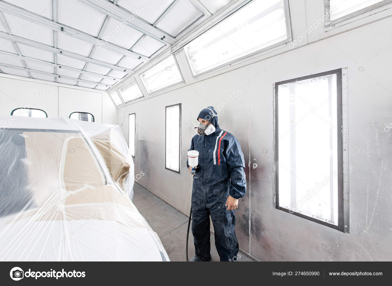 Car Service Station Worker Painting A White Car In Special Garage