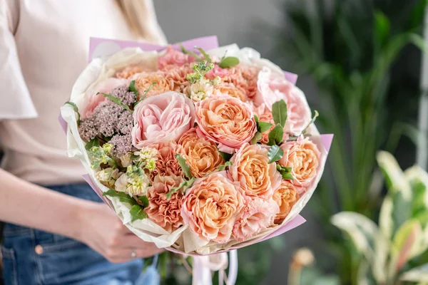 Beautiful bouquet of mixed flowers in woman hand. Floral shop concept . Handsome fresh bouquet. Flowers delivery — Stock Photo, Image