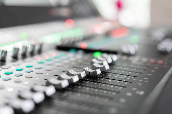 Sound mixer. Professional audio mixing console with lights, buttons, faders and sliders