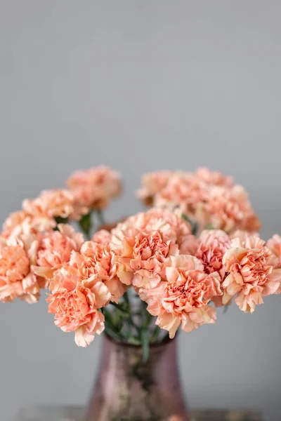 Bouquet of carnation flowers peach color. Spring background. Clove bunch present for Mothers Day.