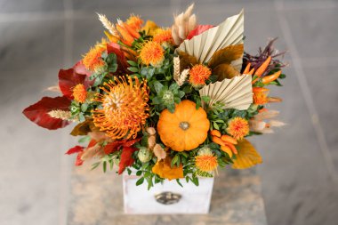 Ahşap masada bir buket karışık çiçek. Çiçekçi dükkanındaki çiçekçinin işi. Taze kesilmiş çiçek..