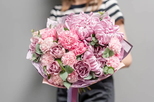 Mooi boeket van gemengde bloemen in vrouwen handen. het werk van de bloemist in een bloemenwinkel. Delicate pastelkleur. Verse snijbloem. Roze kleur — Stockfoto