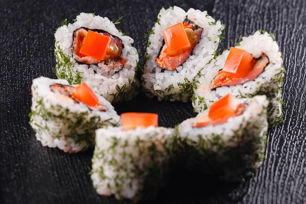 Japanese food, tasty of meal for lunch. Seafood. Sushi with eel, salmon, trout, tuna black background. — Stock Photo, Image