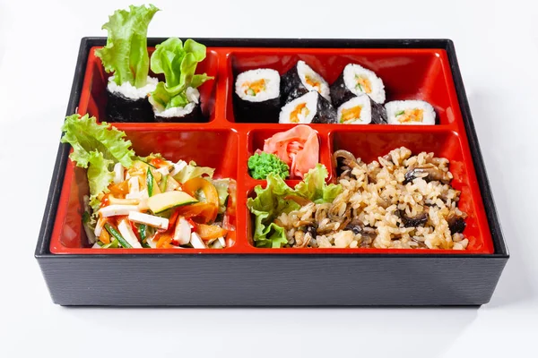 Rice with mushrooms. Fresh food portion in japanese bento box with salad, main course. Sushi roll with vegetables. Vegetarian dish. — Stock Photo, Image