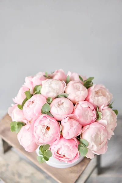 Pink peonies in pink round box. Beautiful peony for catalog or online store. Floral shop concept. Flowers delivery