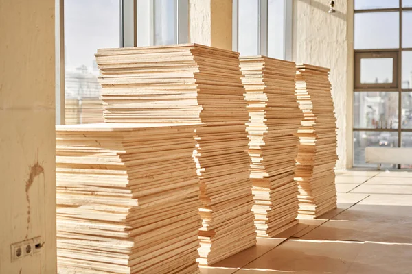 Plywood boards on the industry. layer of plywood, Construction site preparation for the flooring of the parquet floor. Restoration of the floor in a restaurant or apartment.